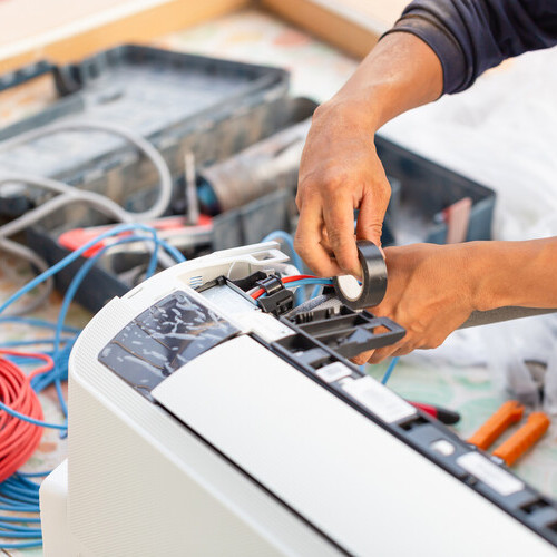 technician installing air conditioner parts